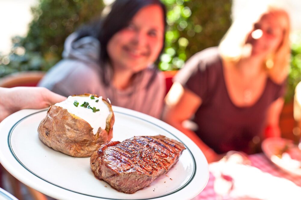 Hannover Am Kröpcke Steak und eine gefüllte Ofenkartoffel werden auf einem Teller serviert
